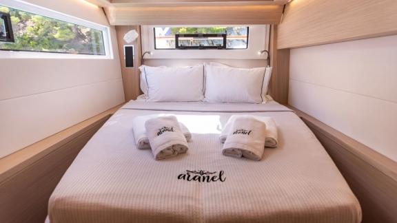 The cabin of Aranel catamaran in Lefkada features a double bed, side windows and natural light.