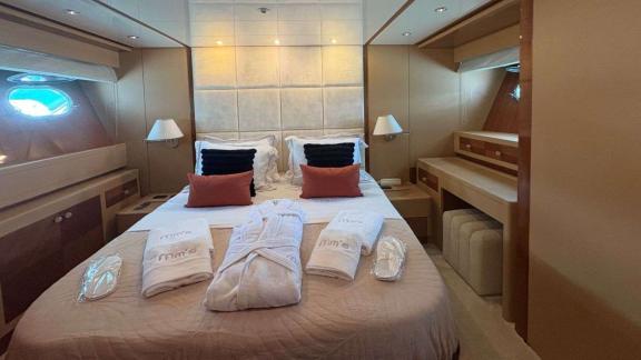 Among Athens yacht options double cabin of Mammas motor yacht with double bed and resting area.