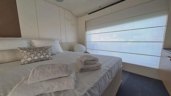 In Sibenik motor yacht charter option First Horizon cabin with double bed and window area visible.