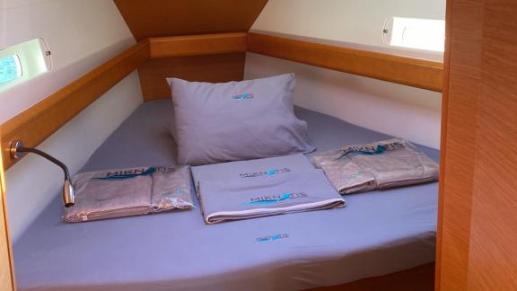 The cabin of the Yerdeniz sailing yacht features a comfortable bed and neatly arranged bedding.