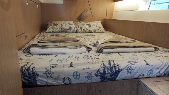 Another double cabin on the sailing yacht Blue Monkey with maritime-themed bedding and a comfortable bed.