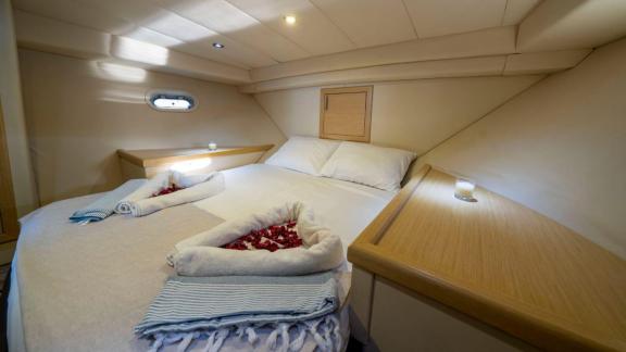 Luxury cabin of motor yacht Moonlight with a comfortable bed and stylish details.