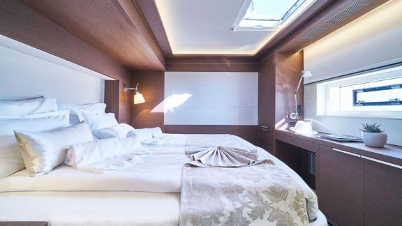 Spacious cabin with large bed and natural light through the skylight on Lagoon Seventy 7.