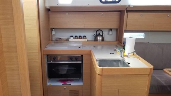 The cockpit of the sailing yacht Ares is equipped with helm wheels and a central table.