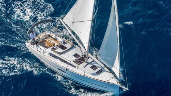 The sailing yacht Gracia is seen from above, sailing on the blue sea.