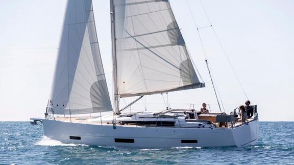 The sailboat Joy 5 is shown sailing in the open sea.