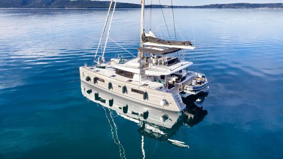 Stylish catamaran on mirror-like waters in Kastela. Enjoy luxurious sailing adventures on the Adriatic Sea.