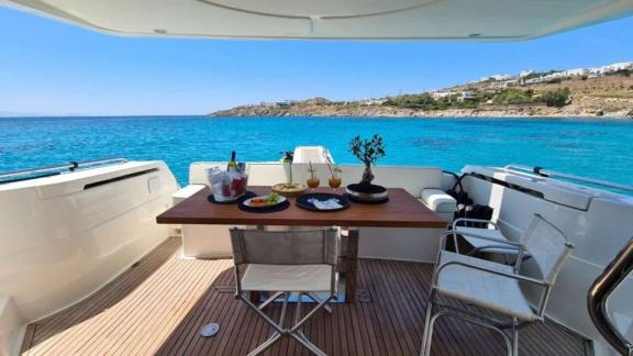 Secret features an aft deck dining area for private motor yacht charters and enjoyable blue cruise experiences in Mykono