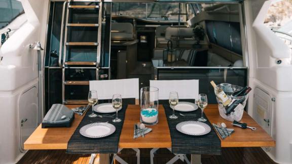 Secret features an elegant aft deck dining area for luxury motor yacht charters and private yacht holidays in Mykonos.
