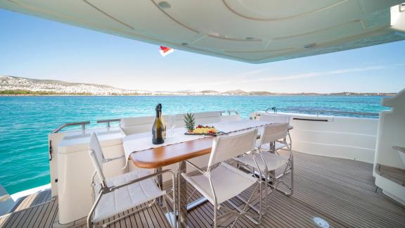Simply Brilliant offers an aft deck dining area with sea views for private motor yacht charters in Mykonos.