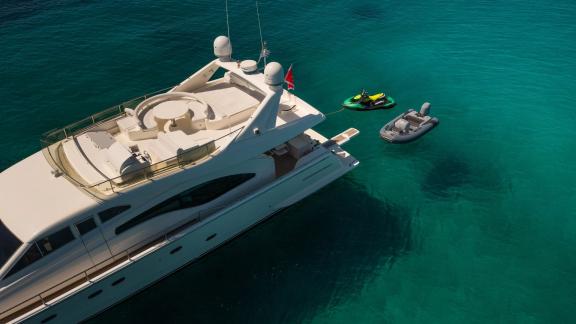 Simply Brilliant features an aft platform with water toys, ideal for private motor yacht charters in Mykonos.