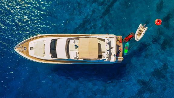 Ferretti 681 Dominique is viewed from above, showcasing its layout and water toys on the stern platform.