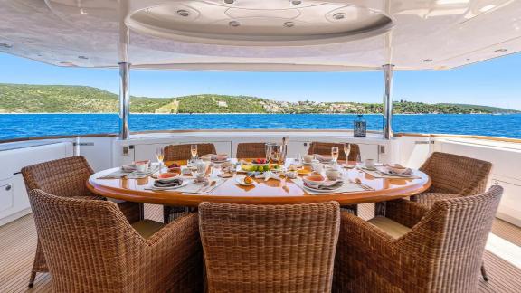 Horizon Elegance 115 Conte Stefani features an outdoor dining area on the upper deck with panoramic sea views.