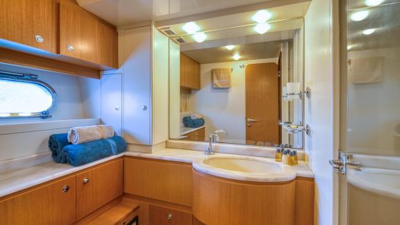 Ferretti 681 Dominique features a bathroom with a large mirror, washbasin unit and practical storage space.