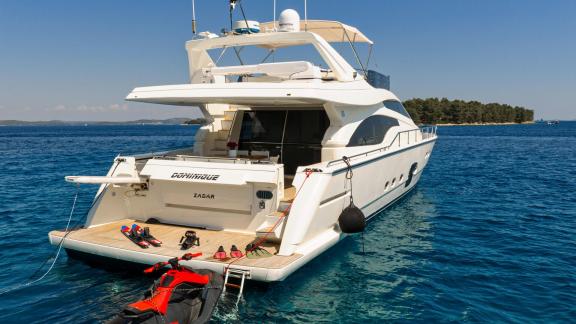 Ferretti 681 Dominique features a spacious stern platform, swim ladder and water sports equipment.