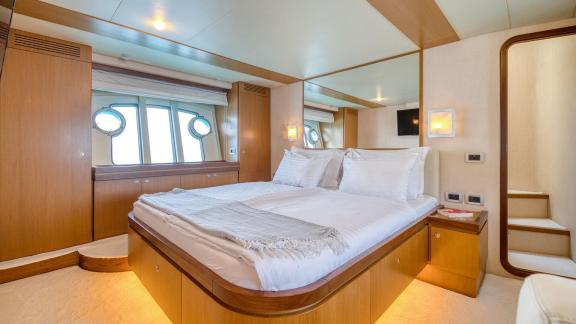 Ferretti 681 Dominique features a master cabin with a double bed, wood finishes and large windows.