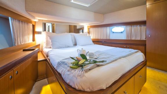 Ferretti 681 Dominique features a guest cabin with a spacious double bed, wood finishes and natural light.