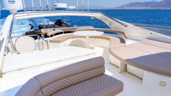 Among Athens yacht rental options Sofia D upper deck shows seating and sunbathing area with sea view.