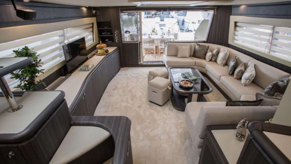 Among Athens yacht rental options Sofia D interior shows seating area with TV and modern layout.
