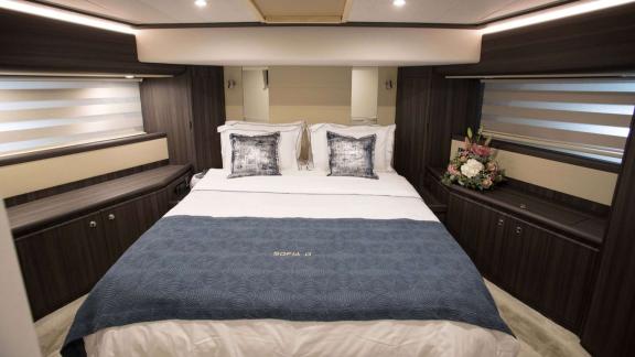 Among Athens yacht rental options Sofia D cabin shows large double bed with modern interior and comfort.