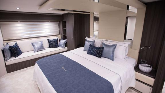 Among Athens yacht rental options Sofia D cabin shows double bed with side seating area for comfort.