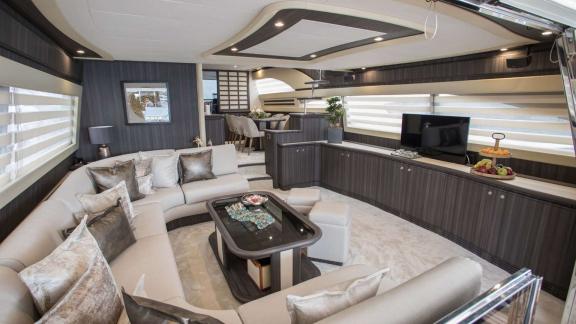 Among Athens yacht rental options Sofia D interior shows modern lounge with comfortable seating area.