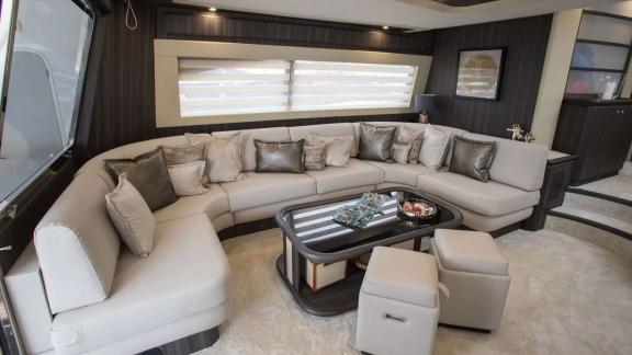 Among Athens yacht rental options Sofia D interior shows large corner seating area with modern comfort.