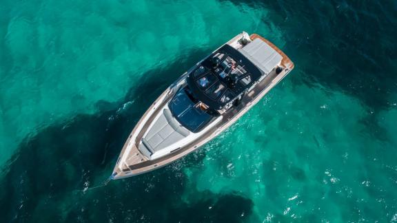 The Bombon motor yacht is anchored over the turquoise waters off Mallorca.