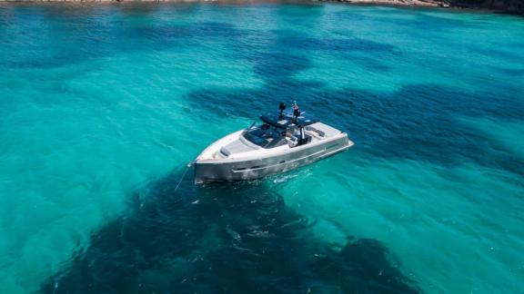 The Bombon motor yacht anchored in the crystal-clear turquoise waters off Mallorca.