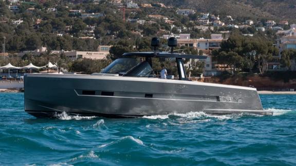 The Bombon motor yacht glides over calm waters along the coast of Mallorca.