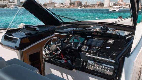 The helm station of the Bombon motor yacht features digital displays and a multifunction steering wheel.