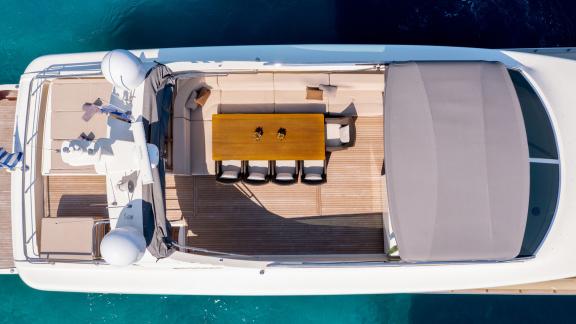 Spacious seating and dining area on the upper deck of the Miraval yacht.