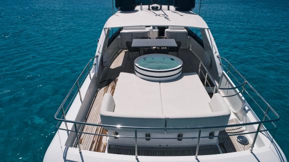 The upper deck of Lady KC offers the perfect setting for enjoying the jacuzzi against turquoise waters.