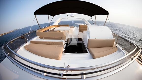 Seating area on the flybridge of the Hasard yacht with a sea view.