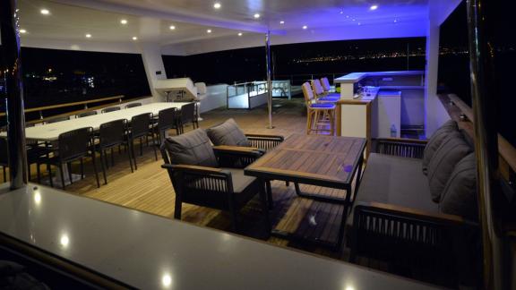 Spacious seating and dining area on the night upper deck of the trawler Nayk 3 anchored in Göcek.