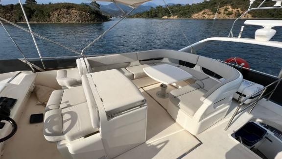 Comfortable seating area on the flybridge of motor yacht Sky 22 with a sea view offers enjoyment.