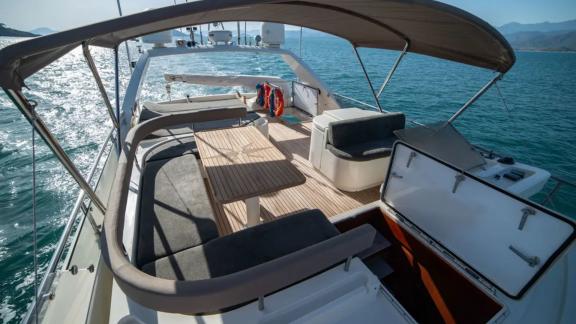 Spacious upper deck of the Hurrem motor yacht with comfortable seating areas and stunning sea view.