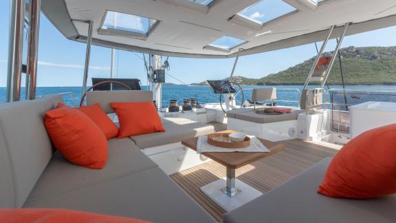 Cozy relaxation area with comfortable sofas and sea view on the Serenissima catamaran.