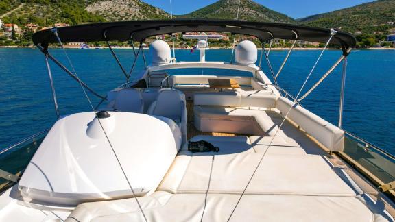 Upper deck of the yacht 2 Drunk with a spacious seating area and surrounding views.