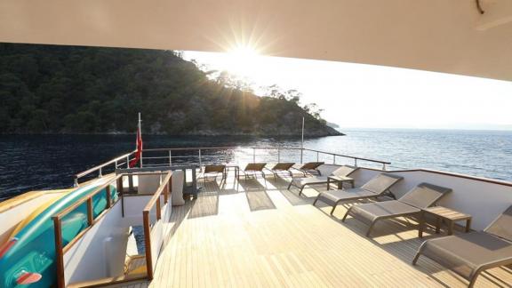 Sun loungers and sunbathing area on the upper deck of the trawler Nayk 3 anchored in Göcek.