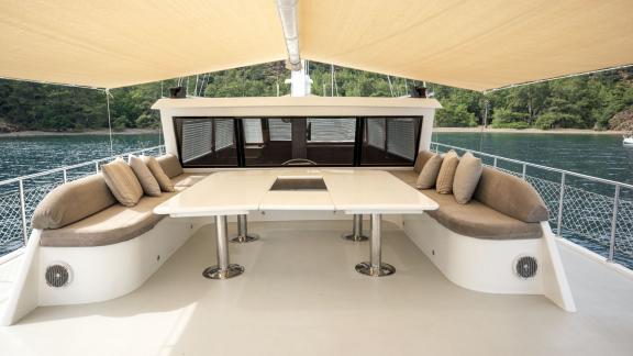 Cozy seating area on the sundeck of the Gulet Kayhan 11 in Fethiye, surrounded by nature.