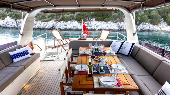 The upper deck of Sveti Sky features spacious cushioned seating areas with open sea views.