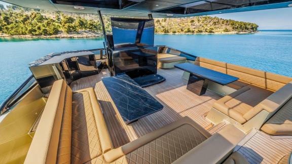 The spacious and shaded flybridge on Over the Moon offers a luxurious charter setting in the waters of Split.