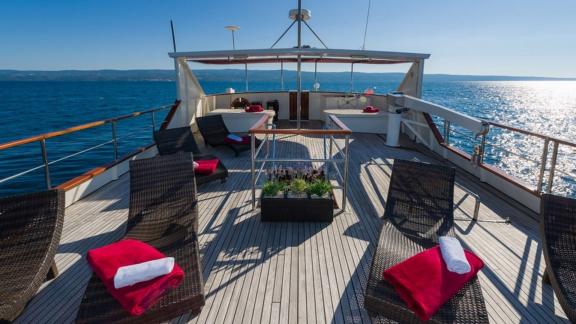 Lounge under the sun on Korab's deck with sea views and relaxing sunbeds.