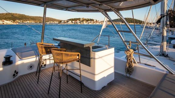 Enjoy drinks at the flybridge bar of Sunreef 60 Mr. Si while taking in breathtaking views of the bay and town.