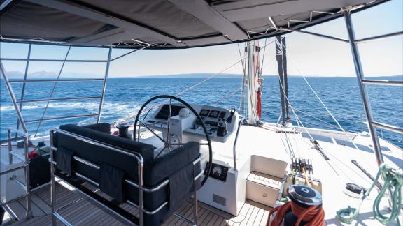 Topaz’s flybridge helm provides optimal control and stunning sea views under a shaded structure.