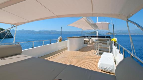 Anchored in Fethiye bays the 6 cabin 12 guest Dodo motorsailer featuring spacious flybridge deck lounge area.
