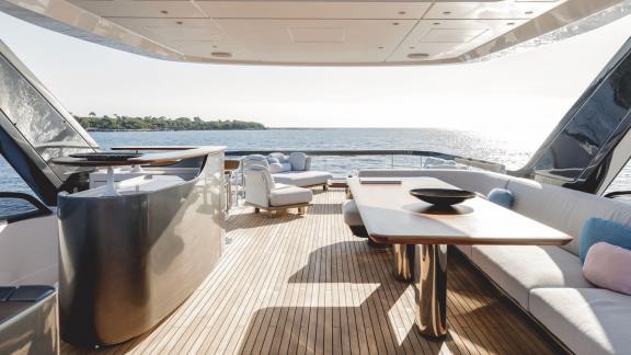In Sibenik motor yacht charter option First Horizon aft deck with dining table and seating area visible.