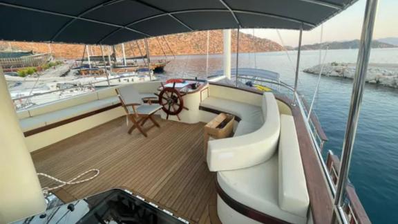 The helm of Gulet Enver Aga in Marmaris offers a comfortable seating area with stunning views of the Turkish coast.