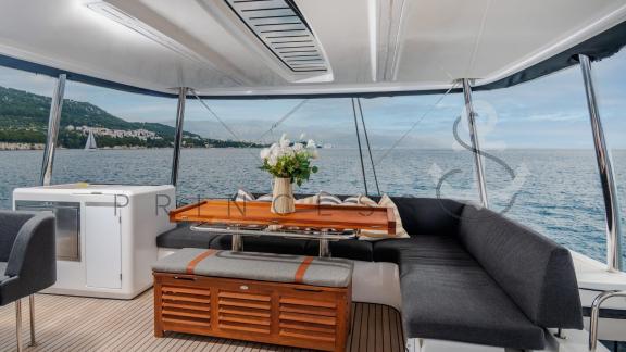 The elegant dining area on the flybridge of the catamaran Princess S with a view of the sea near Dubrovnik, Croatia